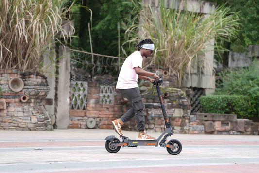 Man riding 2025 Kukirin G2 electric scooter outdoors—showing the scooter's design and practical riding experience