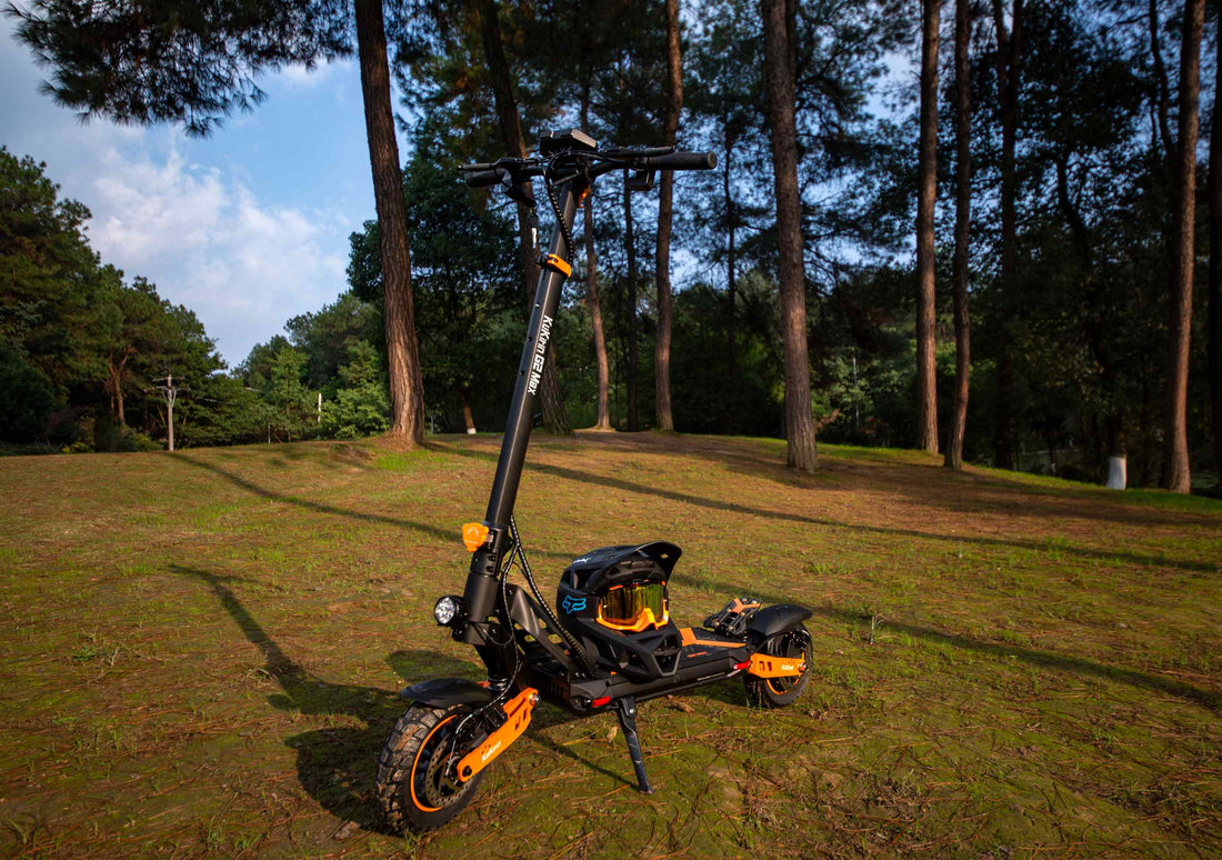 KuKirin G2 Max electric scooter with protective gear in a forest park, showcasing its off-road design for commuter and leisure rides (featured in KuKirin G2 vs G2 Max FAQ guide)