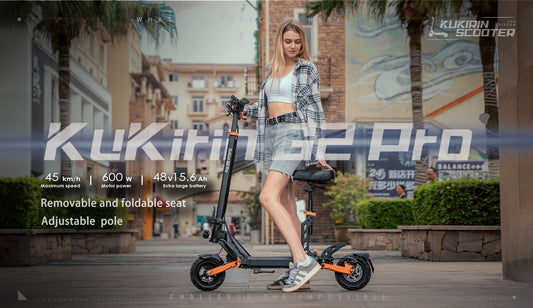 KuKirin G2 Pro electric scooter: A woman stands next to the scooter (black and orange design) with key features labeled: 45 km/h speed, 500W power, 48V 15.6Ah battery, removable foldable seat, and adjustable pole.